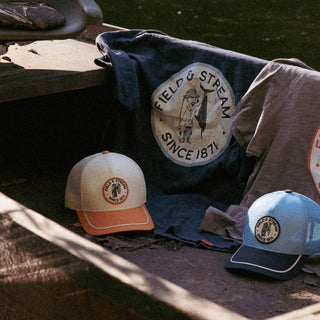 Field and Stream hats and tees in a boat