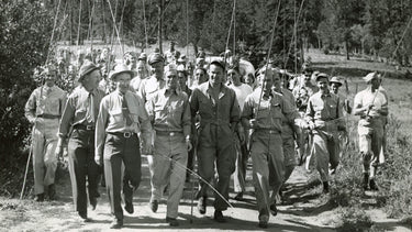 Group of Airforce members from 1940s walking with fishing poles
