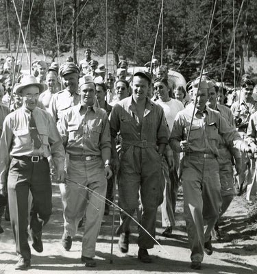 Group of Airforce members from 1940s walking with fishing poles